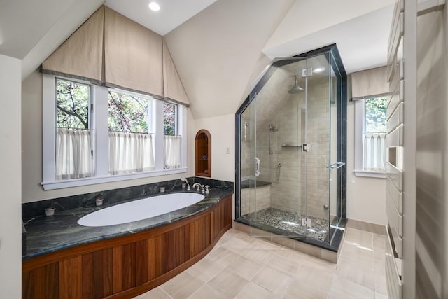 bathroom featuring tile patterned flooring, independent shower and bath, and lofted ceiling