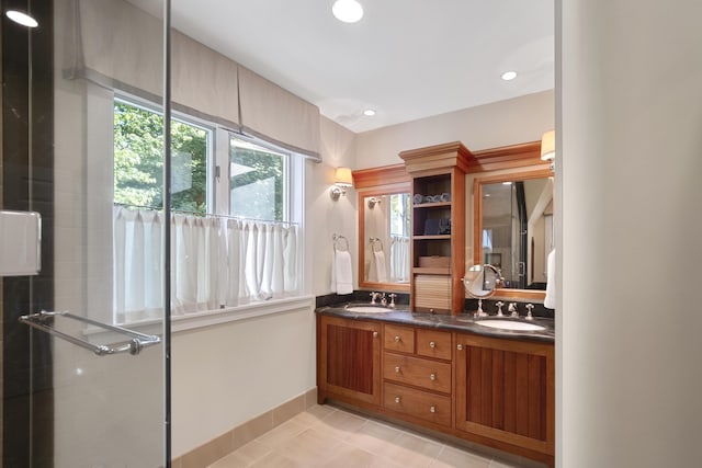 bathroom with tile patterned floors, vanity, and walk in shower