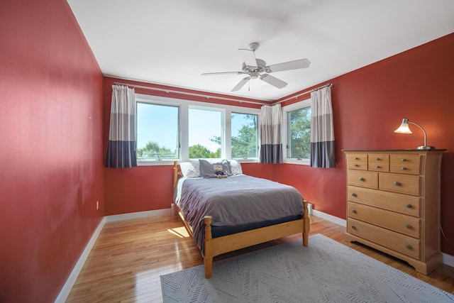 bedroom with ceiling fan and light hardwood / wood-style flooring