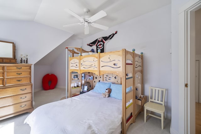 carpeted bedroom with vaulted ceiling and ceiling fan