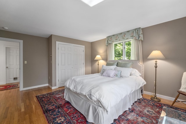 bedroom featuring wood-type flooring and a closet