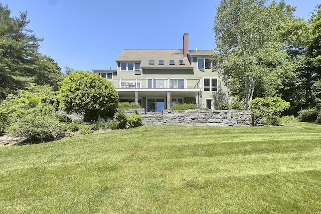 back of house featuring a yard and a deck