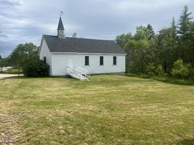 rear view of property with a yard