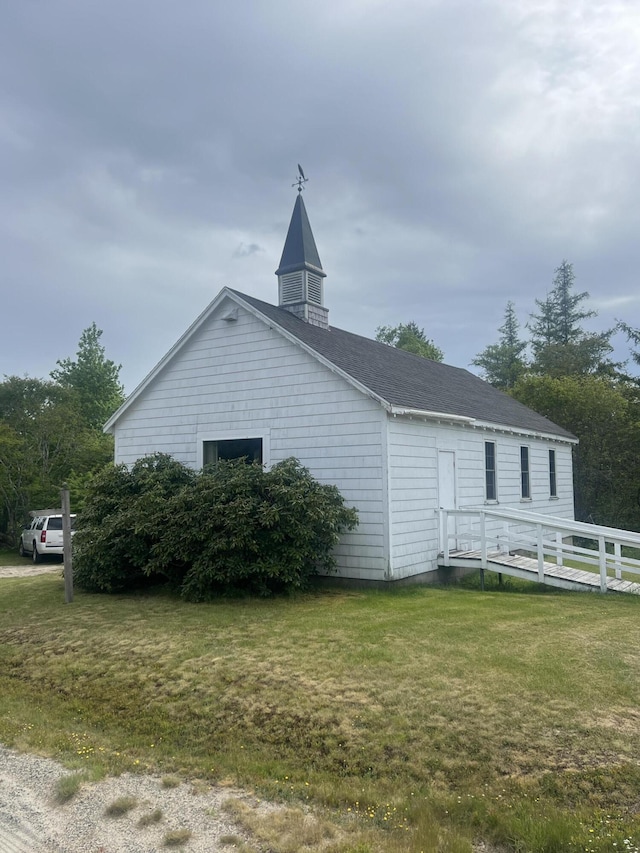 view of side of home with a yard