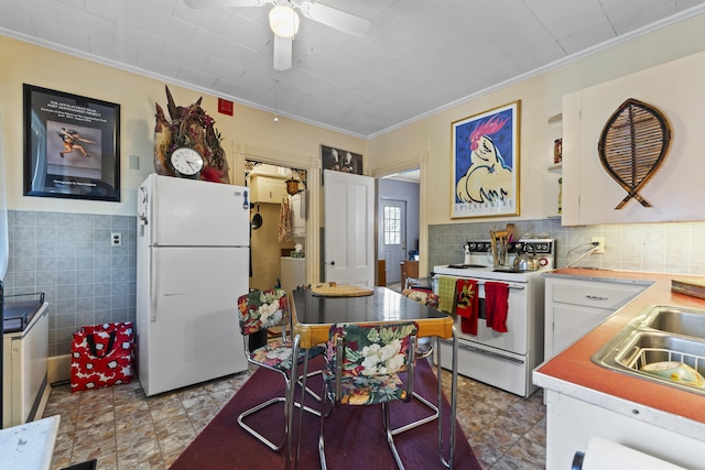 kitchen with ceiling fan, white cabinetry, white appliances, and crown molding