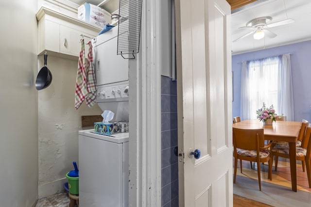 laundry room featuring ceiling fan and stacked washer and clothes dryer