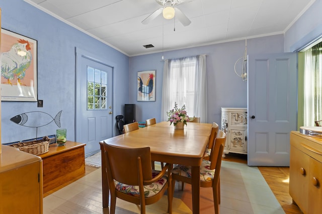 dining space featuring ceiling fan, crown molding, and light hardwood / wood-style flooring