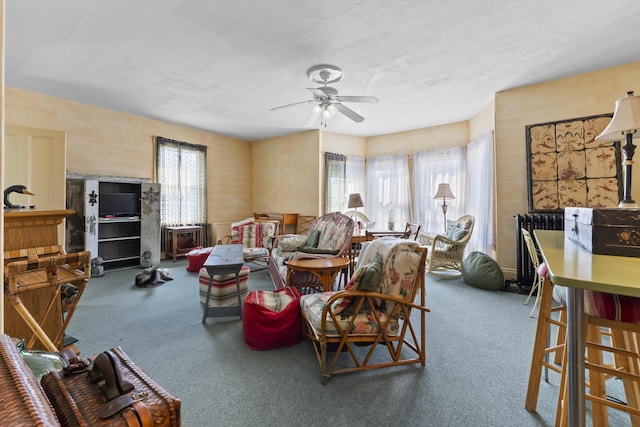 carpeted living room with ceiling fan and plenty of natural light