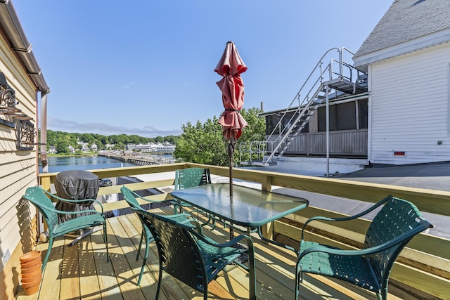 balcony featuring a deck with water view