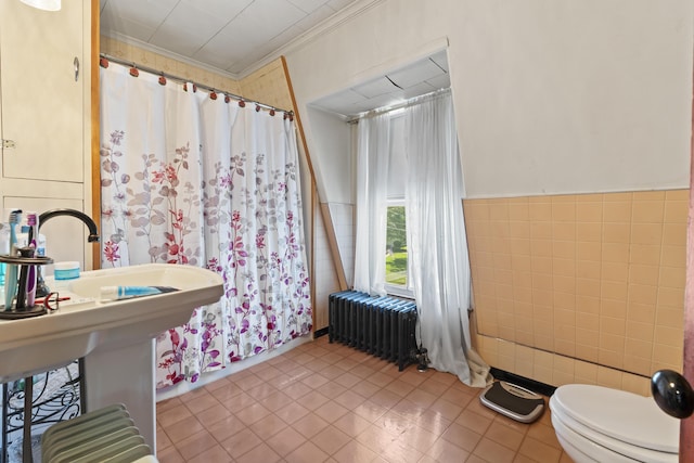 bathroom featuring toilet, tile patterned flooring, tile walls, ornamental molding, and radiator heating unit