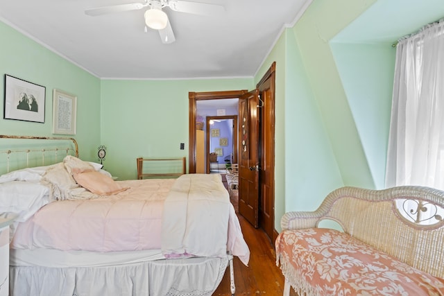 bedroom with ceiling fan, dark hardwood / wood-style flooring, and ornamental molding