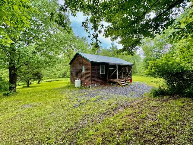 back of house featuring a yard