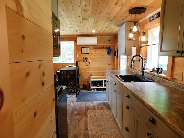 kitchen featuring wood walls, pendant lighting, sink, dark wood-type flooring, and wood ceiling