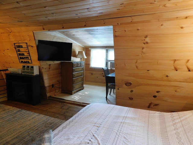 bedroom with cooling unit, wood-type flooring, wooden walls, and wooden ceiling