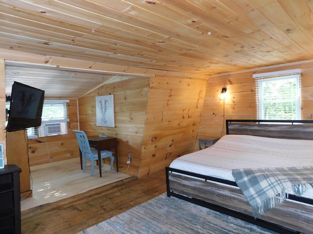 bedroom with wood ceiling, wooden walls, multiple windows, and hardwood / wood-style flooring