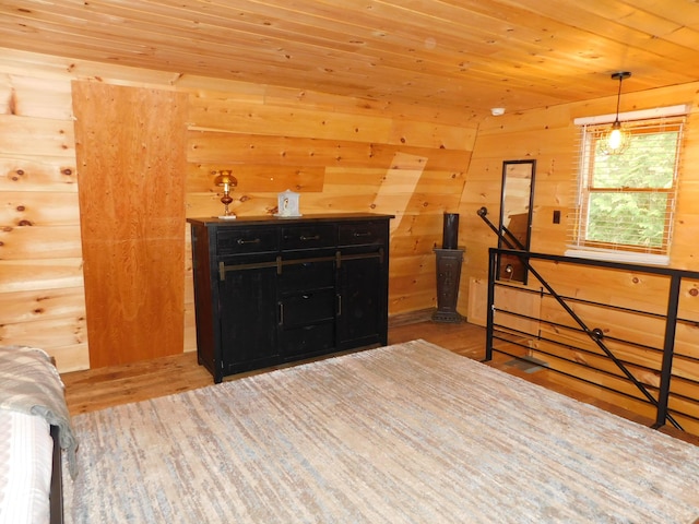 bedroom featuring light hardwood / wood-style flooring, wooden walls, and wooden ceiling