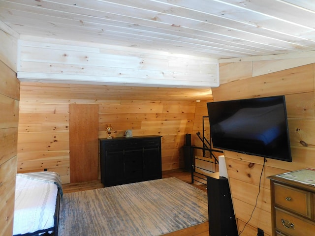 bedroom featuring wood walls