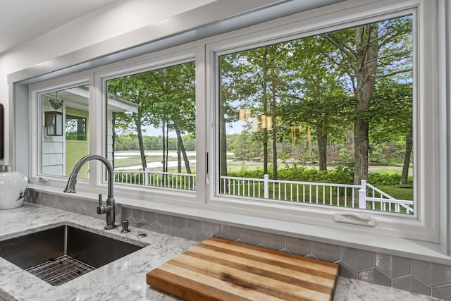 details with light stone countertops and sink