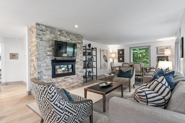 living room featuring a fireplace and light hardwood / wood-style flooring