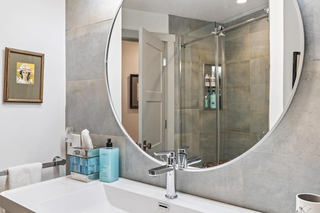 bathroom with vanity and a shower with shower door