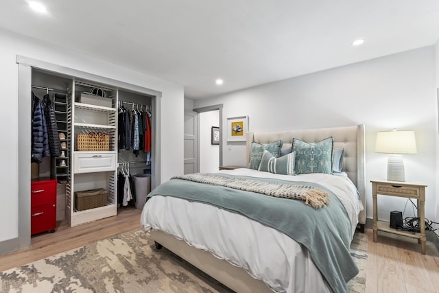 bedroom with wood-type flooring and a closet