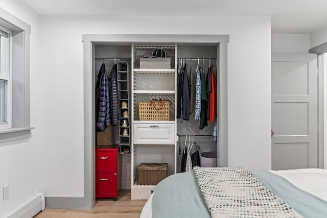 closet with a baseboard heating unit