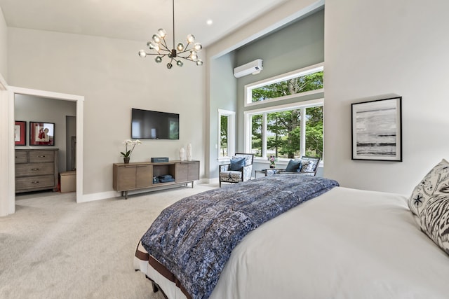 carpeted bedroom with an AC wall unit, a towering ceiling, and a chandelier