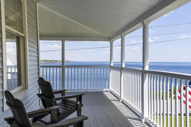 sunroom with a water view and a wealth of natural light