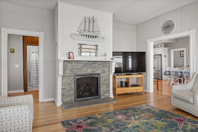 living room featuring wood-type flooring and a fireplace