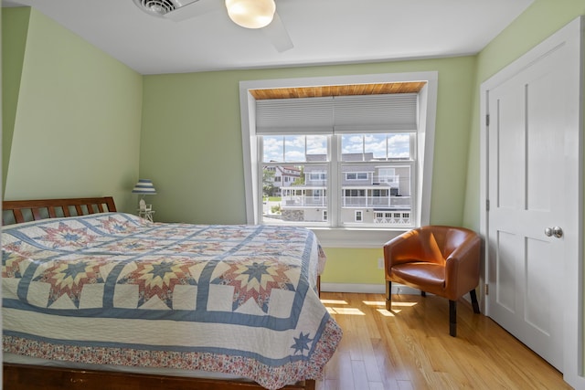 bedroom with ceiling fan and light hardwood / wood-style floors