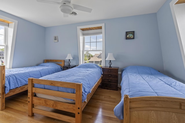 bedroom with hardwood / wood-style flooring and ceiling fan