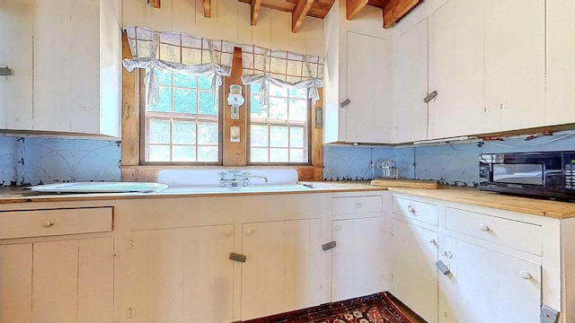677 Friendship Long Is, Friendship, ME 04547 - kitchen featuring wooden ceiling, beam ceiling, and white cabinets