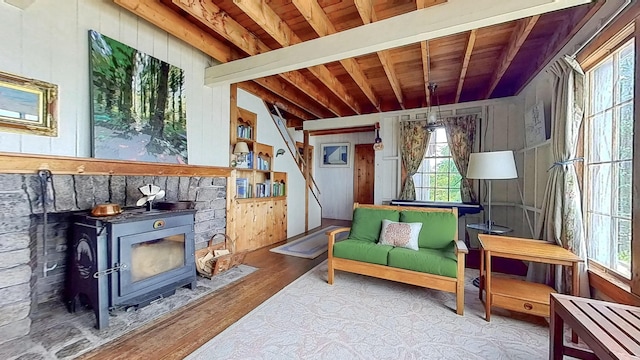 677 Friendship Long Is, Friendship, ME 04547 - living area with wood walls, beamed ceiling, light hardwood / wood-style flooring, wood ceiling, and a wood stove