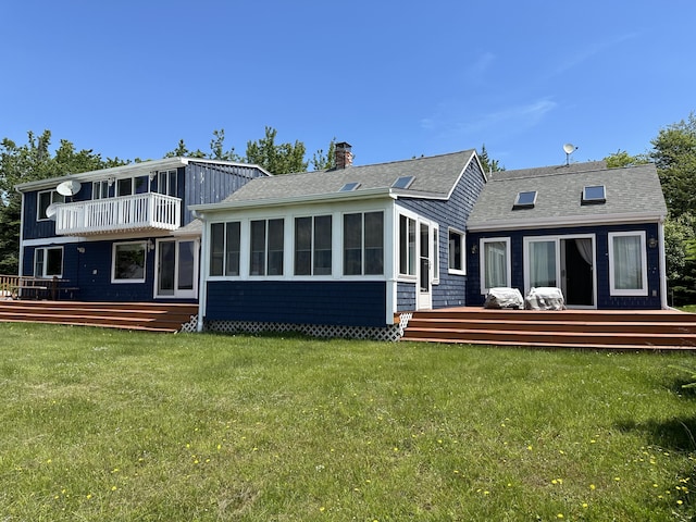 rear view of house featuring a yard