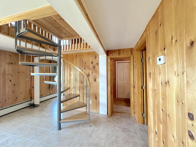 stairs with tile patterned flooring and wood walls