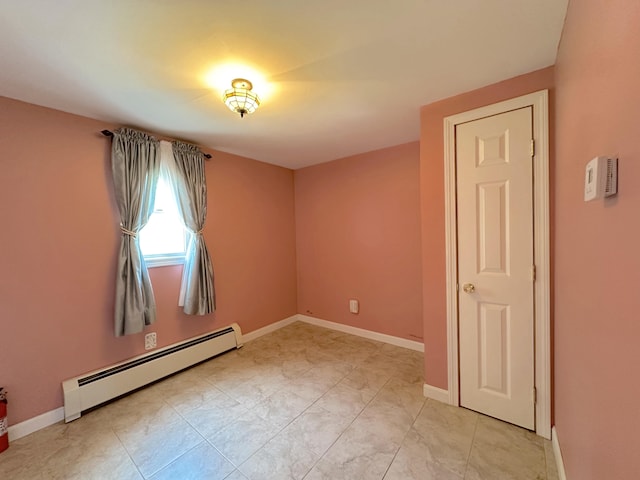 unfurnished room featuring a baseboard radiator