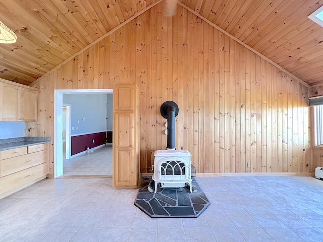 room details with wood ceiling, wood walls, and a wood stove