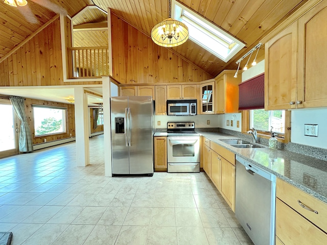 kitchen featuring a skylight, appliances with stainless steel finishes, plenty of natural light, high vaulted ceiling, and sink