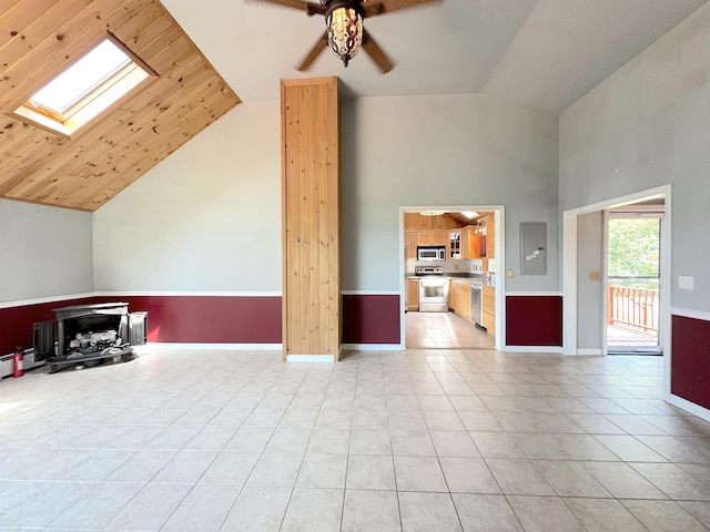 unfurnished living room with wood ceiling, ceiling fan, light tile patterned flooring, vaulted ceiling with skylight, and electric panel