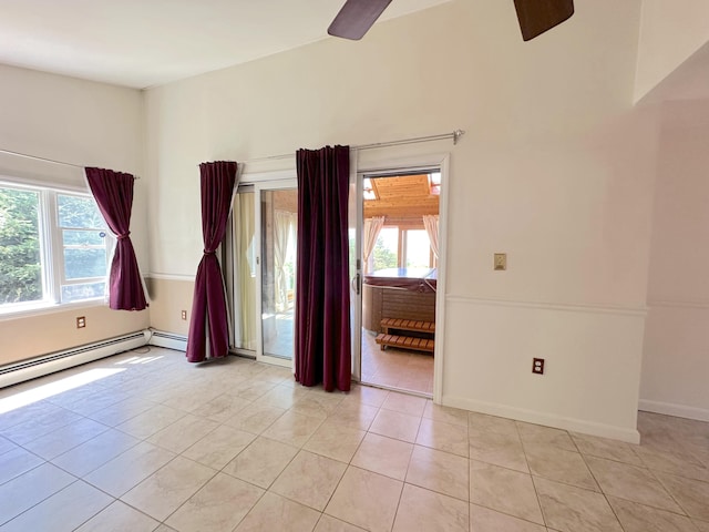 unfurnished room with ceiling fan, light tile patterned floors, and baseboard heating