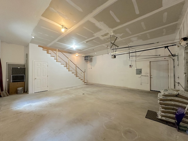 garage featuring a garage door opener and electric panel