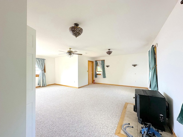 unfurnished living room featuring ceiling fan and light carpet