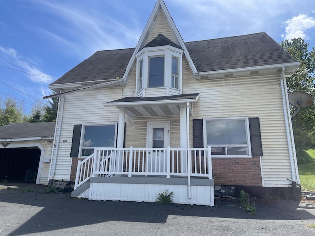 view of front of property with a porch and a garage