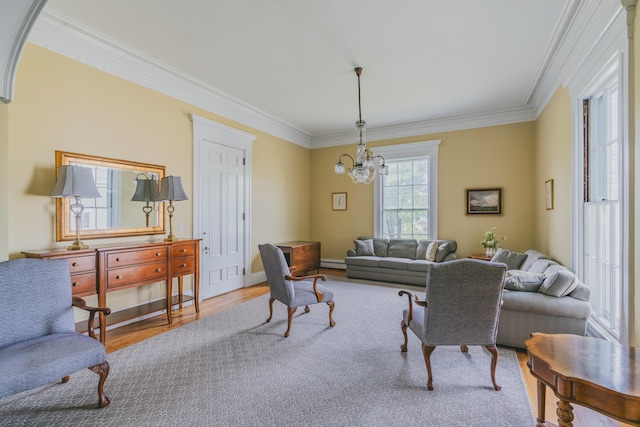 living room featuring a baseboard radiator, light wood-type flooring, ornamental molding, and an inviting chandelier