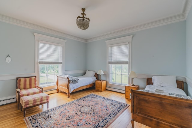 bedroom featuring a baseboard heating unit, ornamental molding, and light hardwood / wood-style flooring