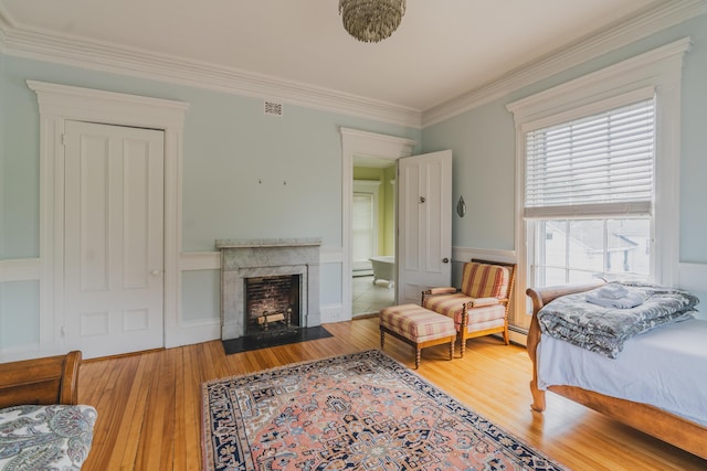 bedroom with crown molding and hardwood / wood-style flooring