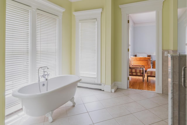 bathroom with a baseboard heating unit, tile patterned floors, crown molding, and a bathing tub