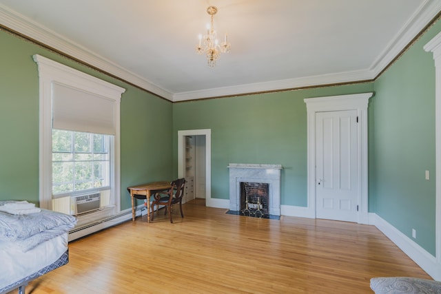 living room with a premium fireplace, ornamental molding, light hardwood / wood-style flooring, and a baseboard radiator