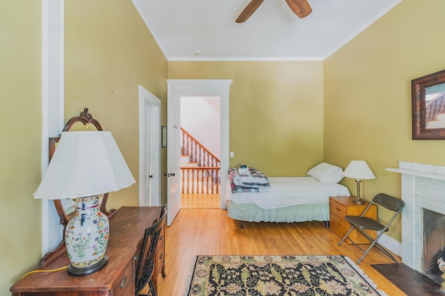 bedroom featuring light wood-type flooring, ceiling fan, and ornamental molding