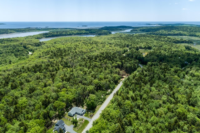 aerial view with a water view and a forest view